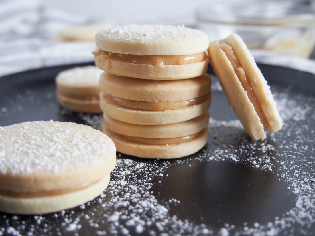 Alfajores - dulce de leche sandwich cookies stack of alfajores with one resting on side