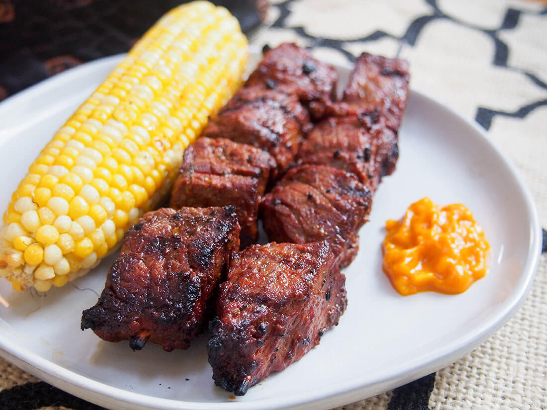 Anticuchos de carne - Peruvian beef skewers - served with corn Anticuchos de carne - Peruvian beef skewers - served with corn