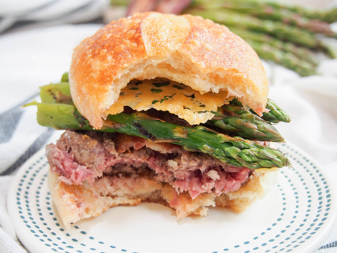 Asparagus parmesan burger with parmesan crisps Asparagus parmesan burger with parmesan crisps with bites taken from it