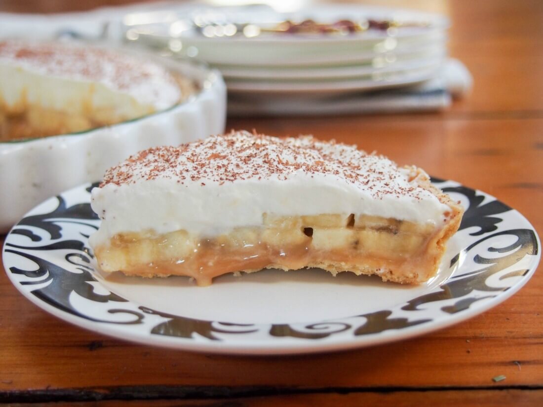 Banoffee pie is an easy but delicious combination - crisp pie base, caramel, banana and cream. It's a favorite in our house, and I hope it'll be in yours too. slice of banoffee pie on plate