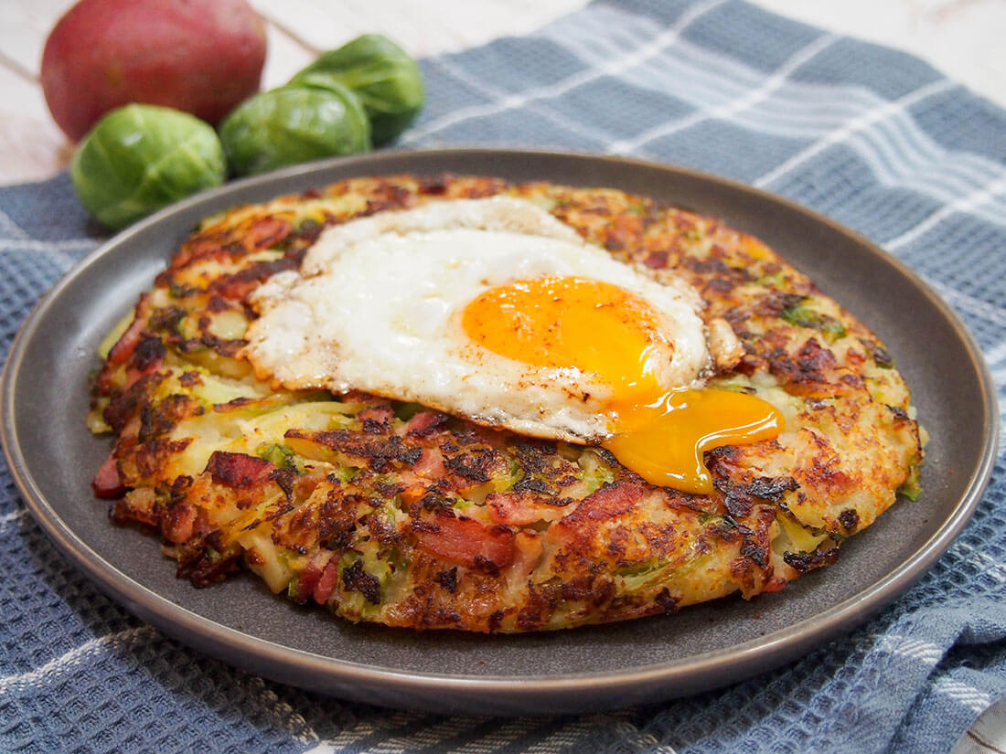 Bubble and squeak is an easy and delicious solution to leftover cooked vegetables. Hearty, filling and perfect any meal, with different ways to serve it. bubble and squeak with egg on top and yolk running