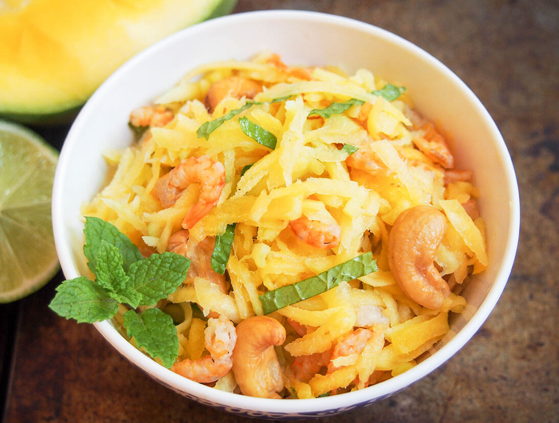 This Cambodian green mango salad is so easy to make and wonderfully fresh. Don't be put off by dried shrimp, they add a great flavor and texture to this simple, light side/appetizer perfect for summer. Cambodian green mango salad in bowl