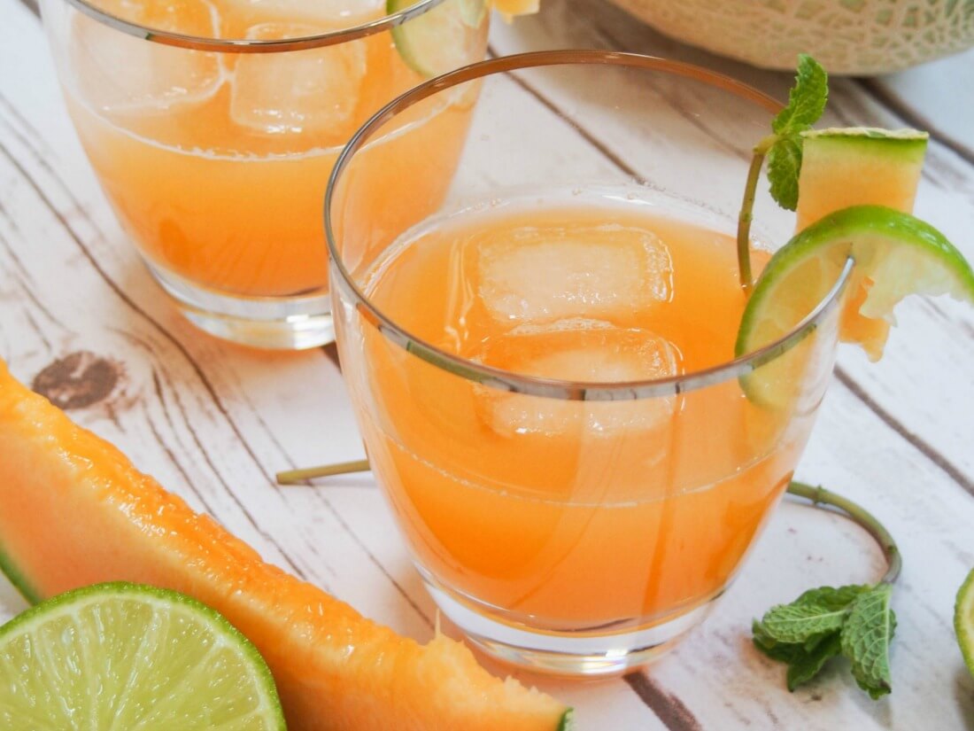 cantaloupe agua fresca is an easy and incredibly refreshing drink, perfect for a warm day. glass of cantaloupe agua fresca with slice of cantaloupe ad lime in front