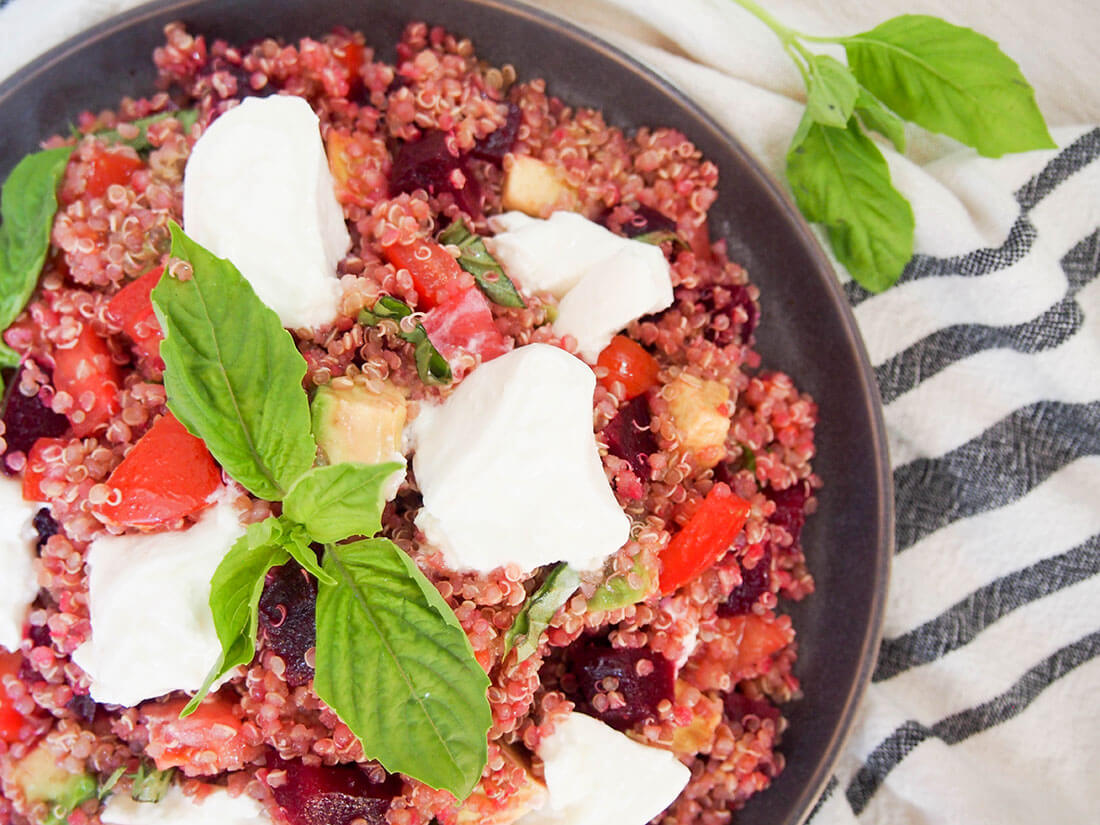 Caprese quinoa salad with beets and avocado - a delicious, light & healthy salad that's perfect for a picnic, potluck or as a side to many a meal! overhead view of part of plate of Caprese quinoa salad with beets and avocado