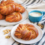 Swedish cardamon buns with one on plate in front