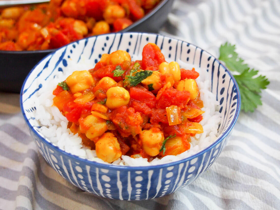 Chana masala (chickpea curry) is a quick, easy and delicious vegetarian curry perfect for any night. Serve it simply with rice, bread, or alongside other dishes for an Indian feast. chana masala over rice in a bowl