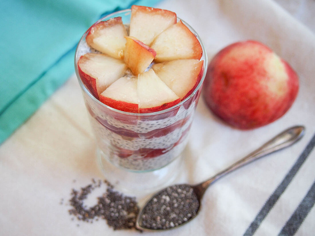 This coconut chia pudding is served with white peach for an incredibly easy but delicious breakfast, snack or dessert. Smooth, creamy and fruity (and dairy free). coconut chia pudding with white peach with peach to side of glass