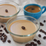coffee panna cotta with espresso cup and part view of a second dish behind