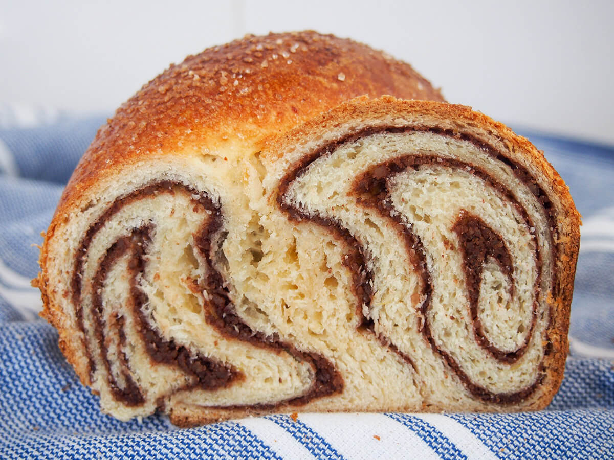 Cozonac is a delicious combination of soft, gently sweet bread and a lightly sweet nut swirl. It is a traditional Easter treat, but is certainly tasty, and pretty, enough to enjoy much more often. cross section of cozonac Romanian Easter bread