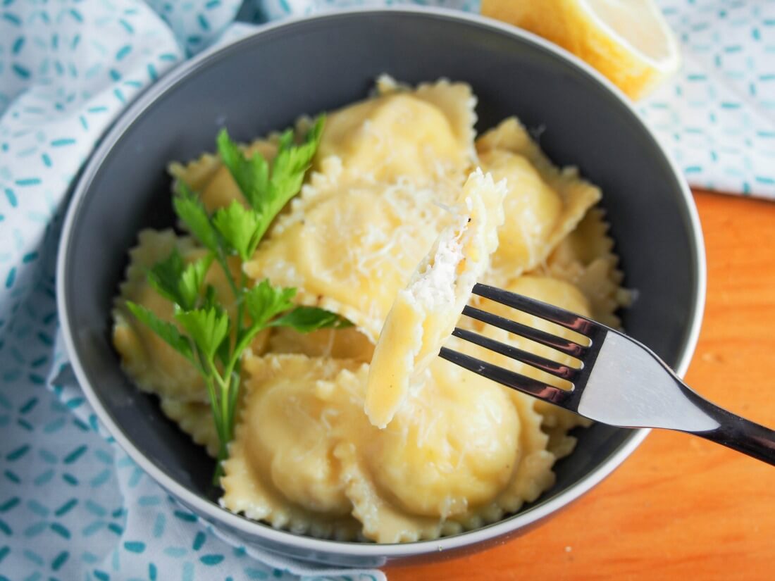 These crab ravioli are delicately flavored, with a smooth, creamy filling jam-packed with crab, wrapped in tasty homemade pasta. So tasty. crab ravioli with one bitten into held on fork over bowl