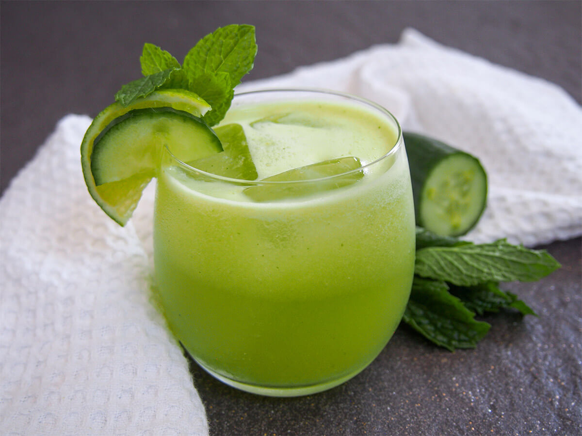 This cucumber agua fresca is bright, light and refreshing. It comes together easily with just a few simple ingredients and is perfect to cool you down on a warm day. glass of cucumber agua fresca garnished with mint, cucumber and lime slices