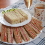 stacked plates with English tea sandwiches close up