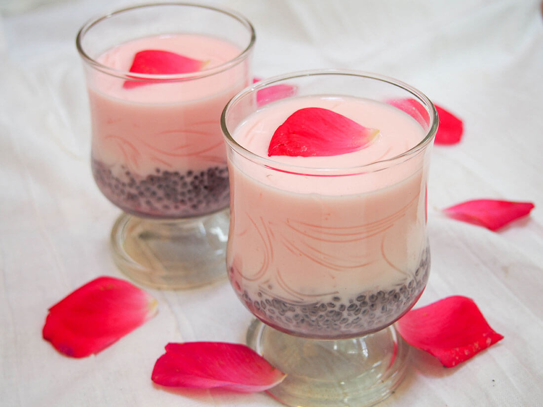 Falooda is a bright, aromatic, rose-flavored drink that almost passes as dessert. You might need a spoon, but it's cooling and perfect for a warm day (and easy to make, too). two glasses of falooda decorated with rose petals