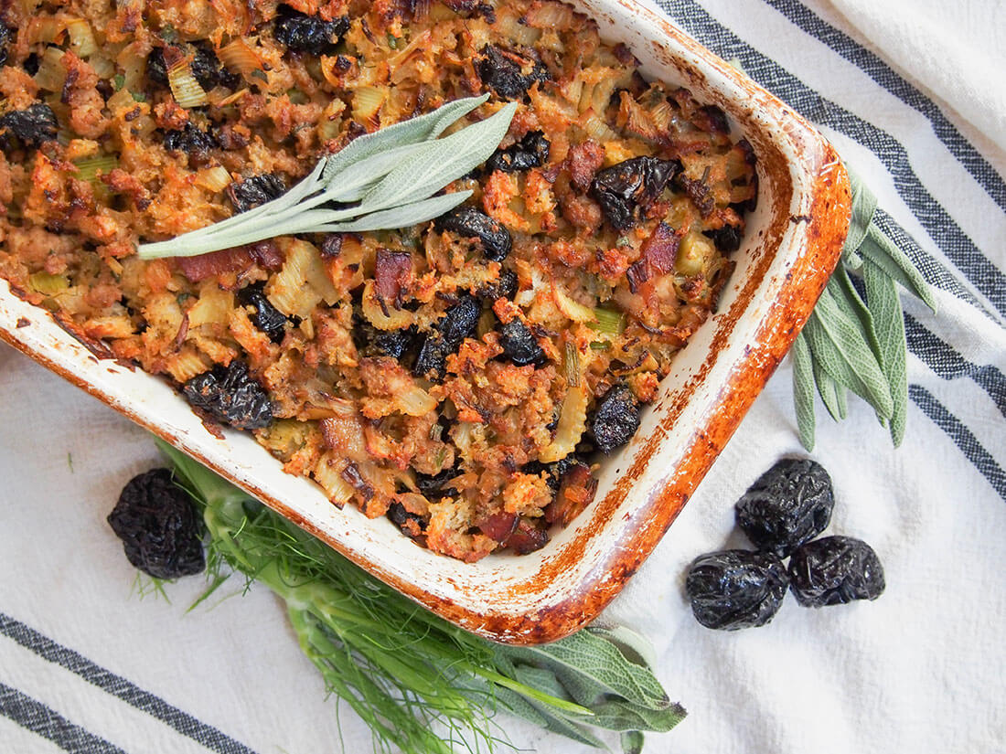This fennel, prune and pork stuffing is easy to put together with a delicious combination of savory flavors with little bursts of sweet prune mixed in. fennel, prune and pork stuffing from overhead showing part of dish