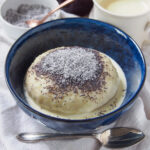 bowl of Germknödel served with vanilla sauce.