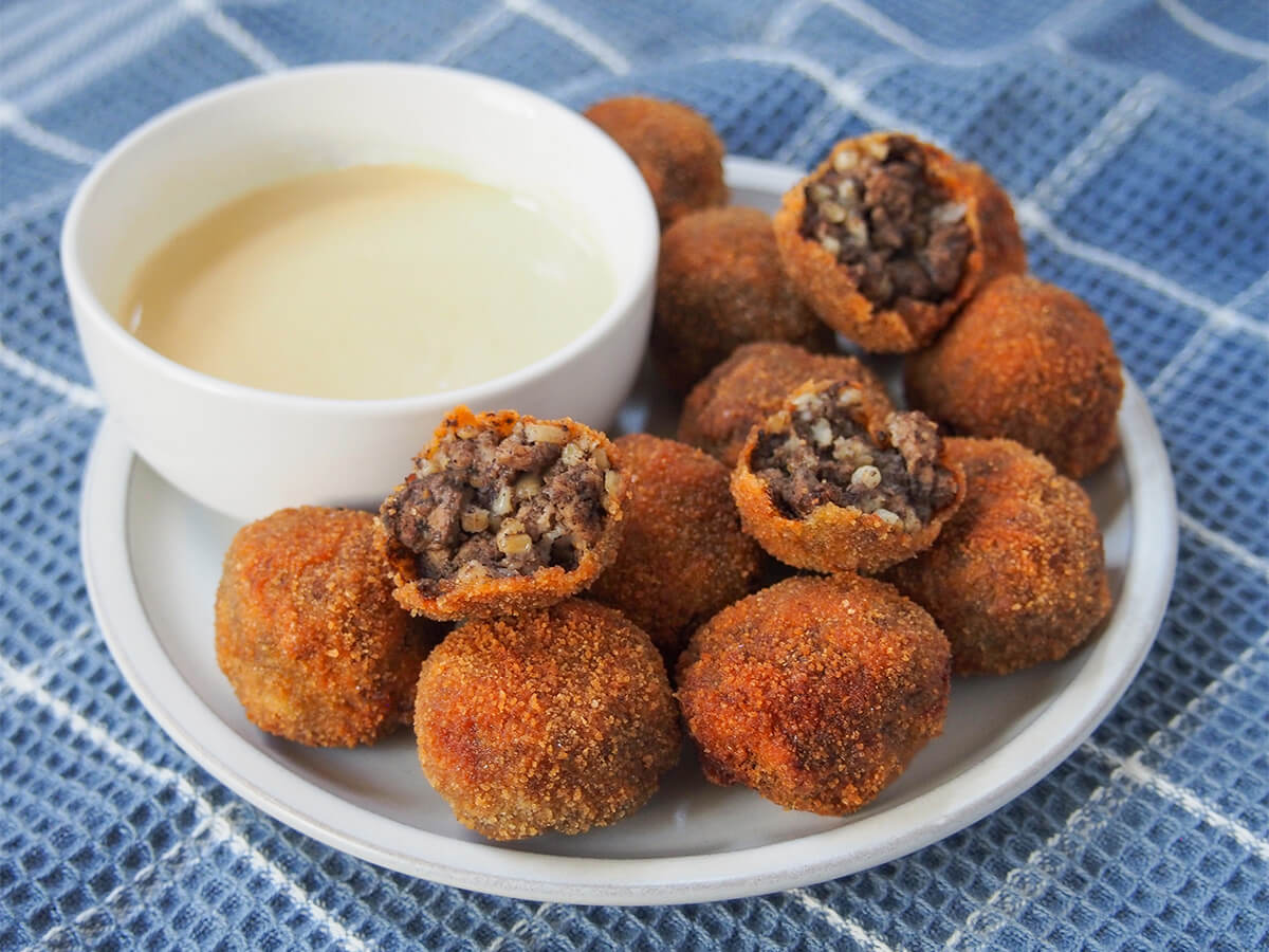 haggis bon bons plate of haggis bon bons with sauce to back side of plate.