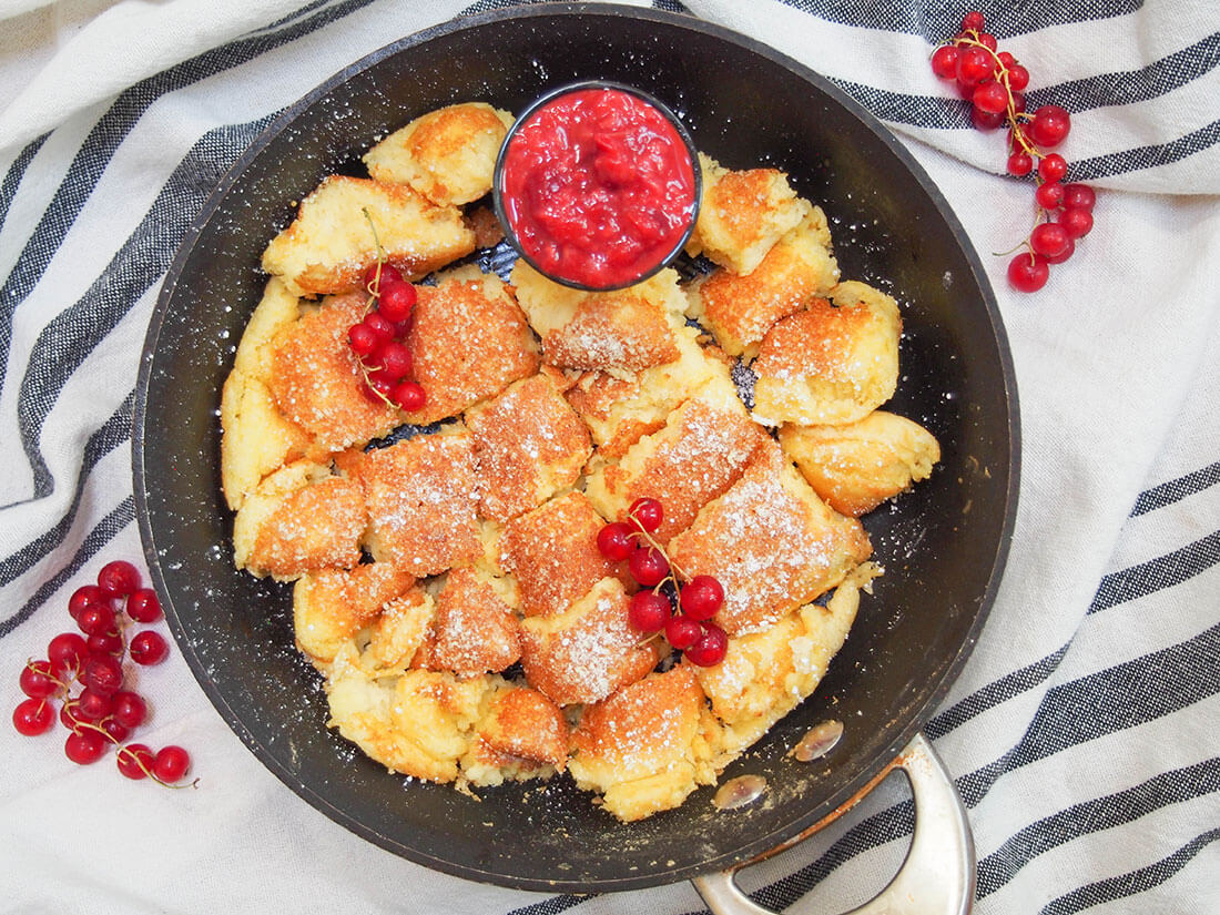 Kaiserschmarrn is a traditional torn-up pancake from Austria. Thick, fluffy, comforting chunks are dusted with sugar and served with fruit compote. Perfect for dessert, brunch or whenever. Kaiserschmarrn (Austrian torn pancakes) with compote on the side