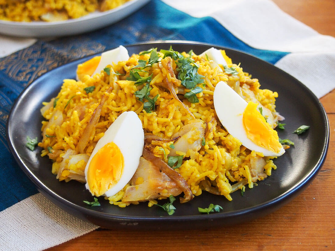 Kedgeree is a hearty and comforting mix of smoked fish and rice with curry flavors. It's a tasty dish that you could enjoy any time of day. plate of kedgeree garnished with hard boiled eggs