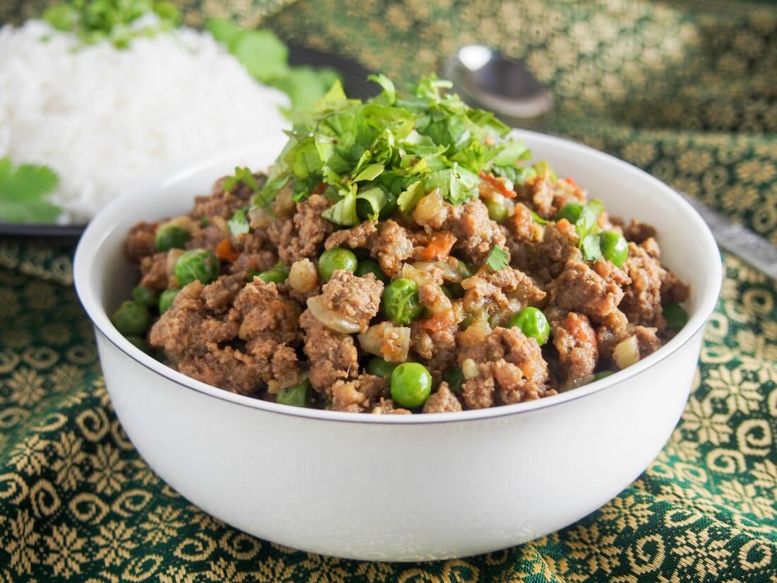 Keema curry (keema matar) is a delicious Indian/Pakistani ground meat and pea curry. Easy to make, and with plenty of flavor, it's a great meal for any night of the week. It's also perfect for meal prep. bowl of keema curry (keema matar) garnished with cilantro