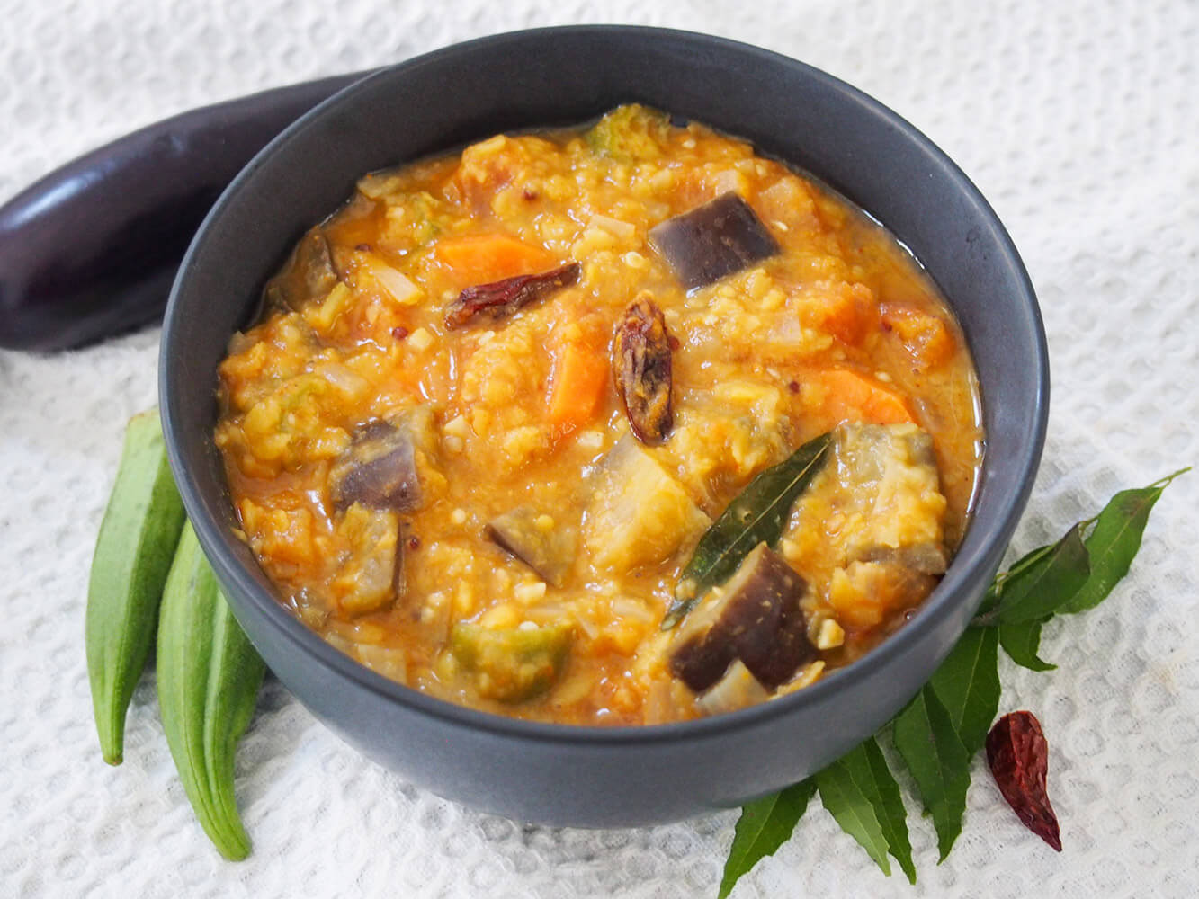 This Kerala style sambar has a tasty mix of vegetables, dal and spices. It's easy to make, comforting and full of delicious flavor. bowl of Kerala style sambar