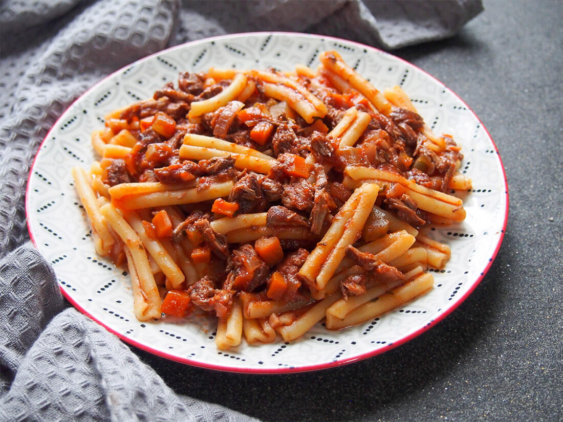 Move over Bolognese, this lamb ragu pasta sauce is even more delicious and comforting. Packed with rich flavor, it's easy to make and perfect for making ahead. lamb ragu pasta on plate