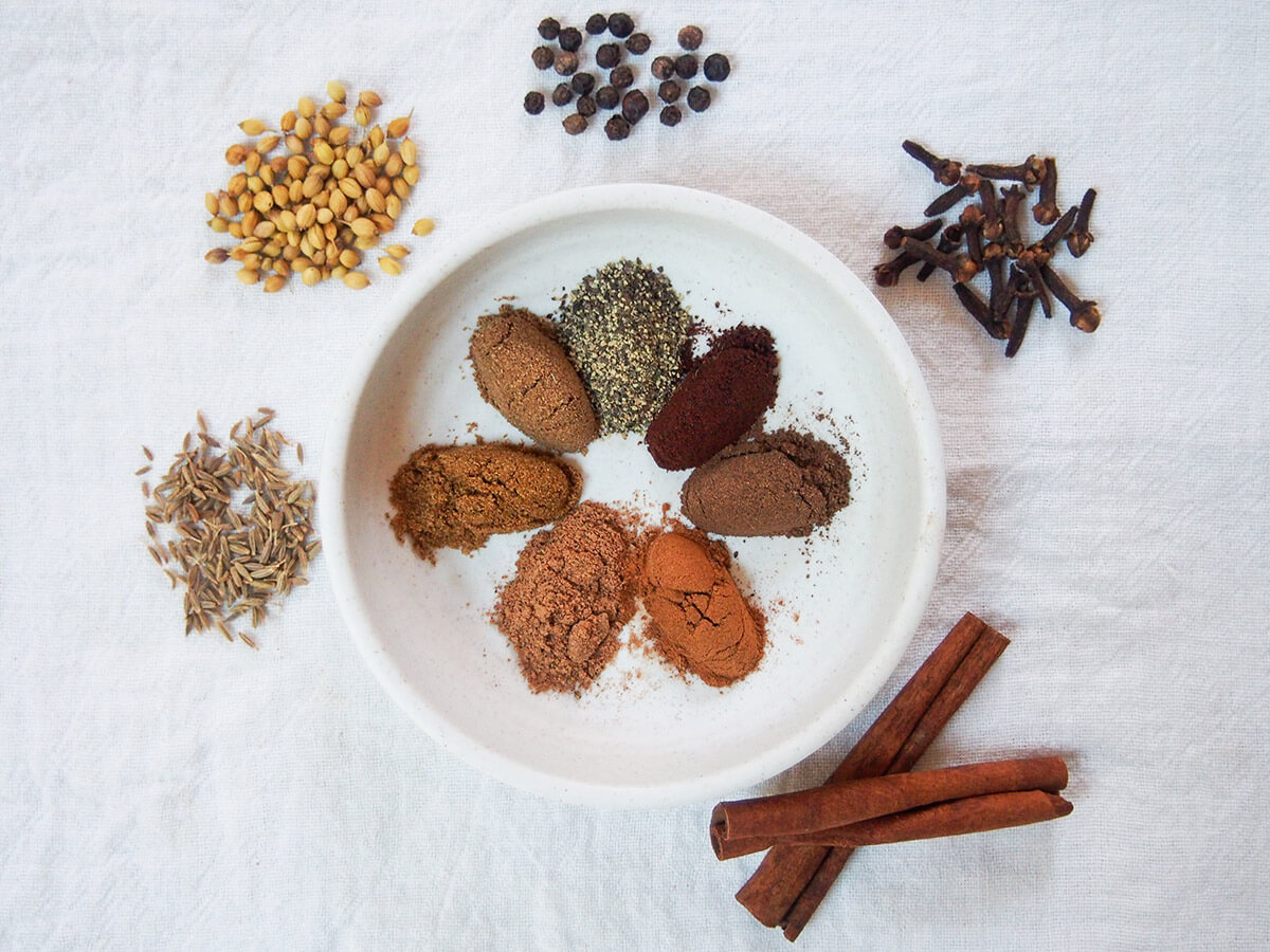 Lebanese seven spice - baharat spice - is a blend that add warm, aromatic flavor to a range of dishes. The mix can vary, and you can adapt to taste too. dish with mounds of spices to make Lebanese seven spices aka baharat with whole spices to side of dish
