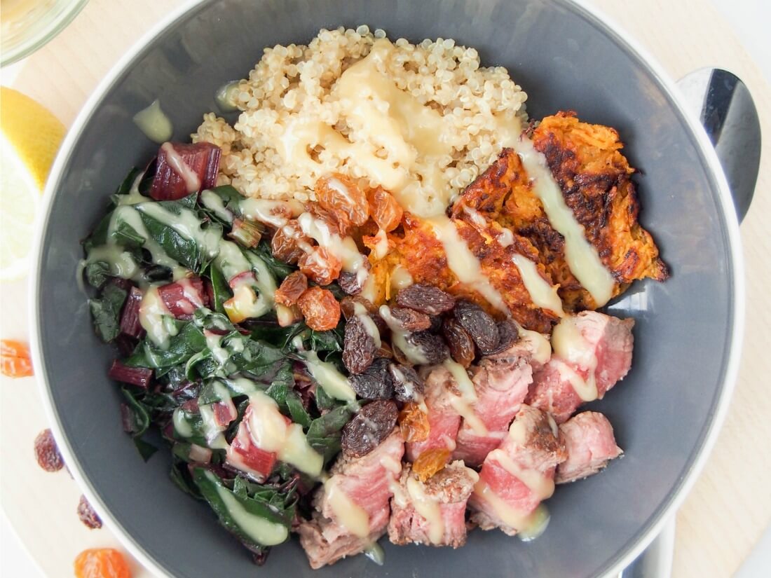Transform leftover steak into this tasty leftover steak and quinoa bowl with sauteed chard and lemon-tahini dressing. A quick, easy, healthy lunch or light meal. leftover steak and quinoa bowl with dressing drizzled over top and spoon to side of bowl