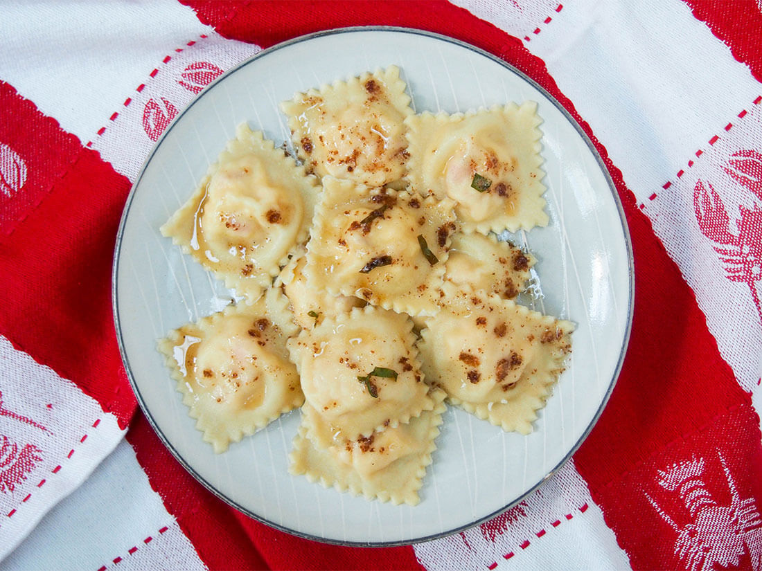There's something special about homemade pasta, and these lobster ravioli are more so than most. Even better, they're not actually that complicated or difficult. The result is delicately-flavored deliciousness! Plate of lobster ravioli on lobster-decorated towel