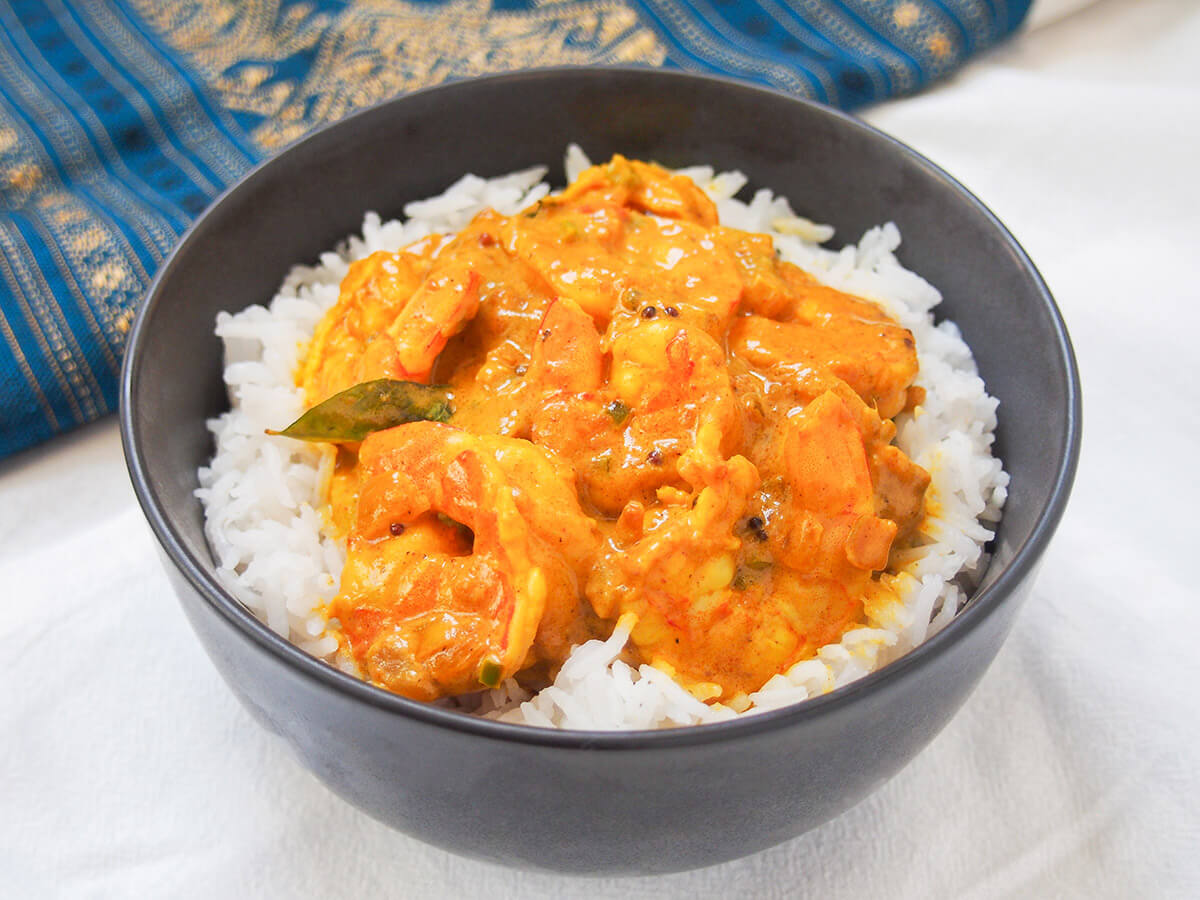 bowl of Malabar prawn curry (Malabar shrimp) bowl of Malabar prawn curry shrimp with blue and gold cloth behind