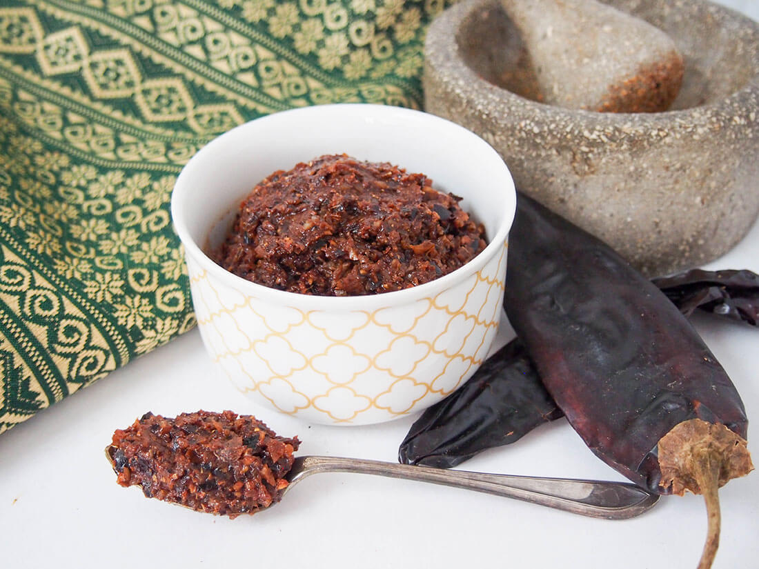 At the base of nearly every delicious curry is a great curry paste. This authentic massaman curry paste has such great depth of flavor, you'll never go back to store bought! massaman curry paste with chilis and pestle and mortar to side