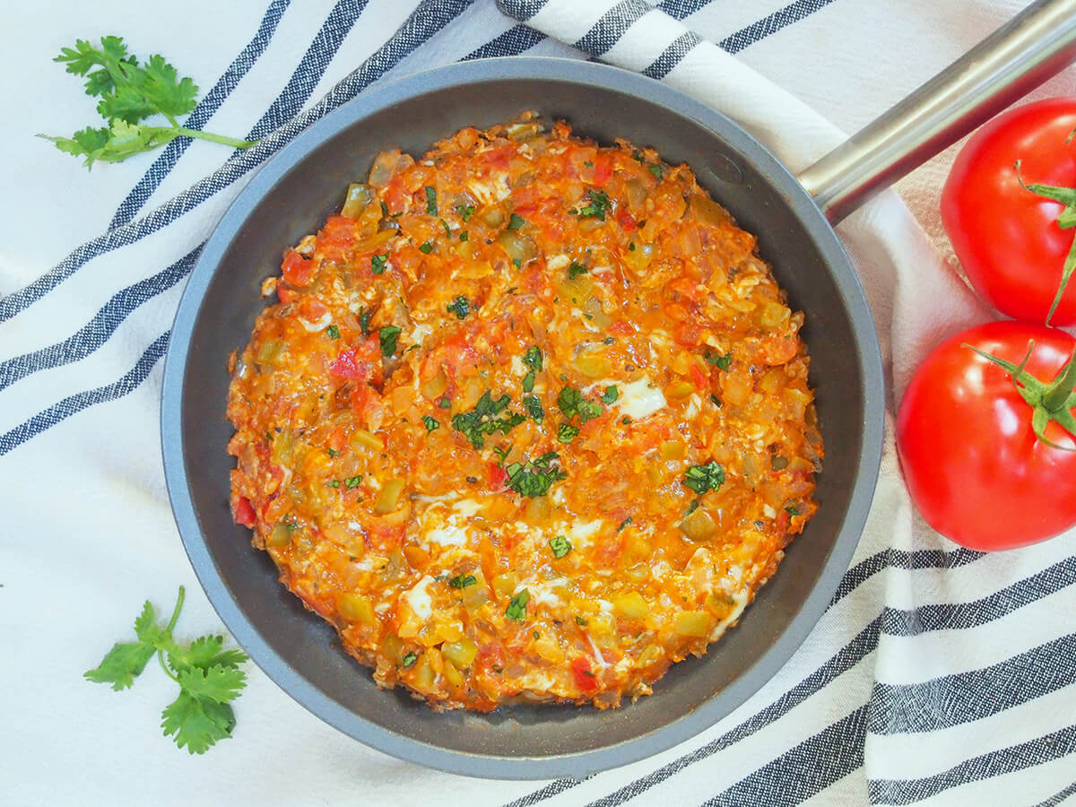 Menemen (Turkish scrambled eggs) is an easy and delicious dish perfect for any meal overhead view of skillet full of menemen, Turkish scrambled eggs