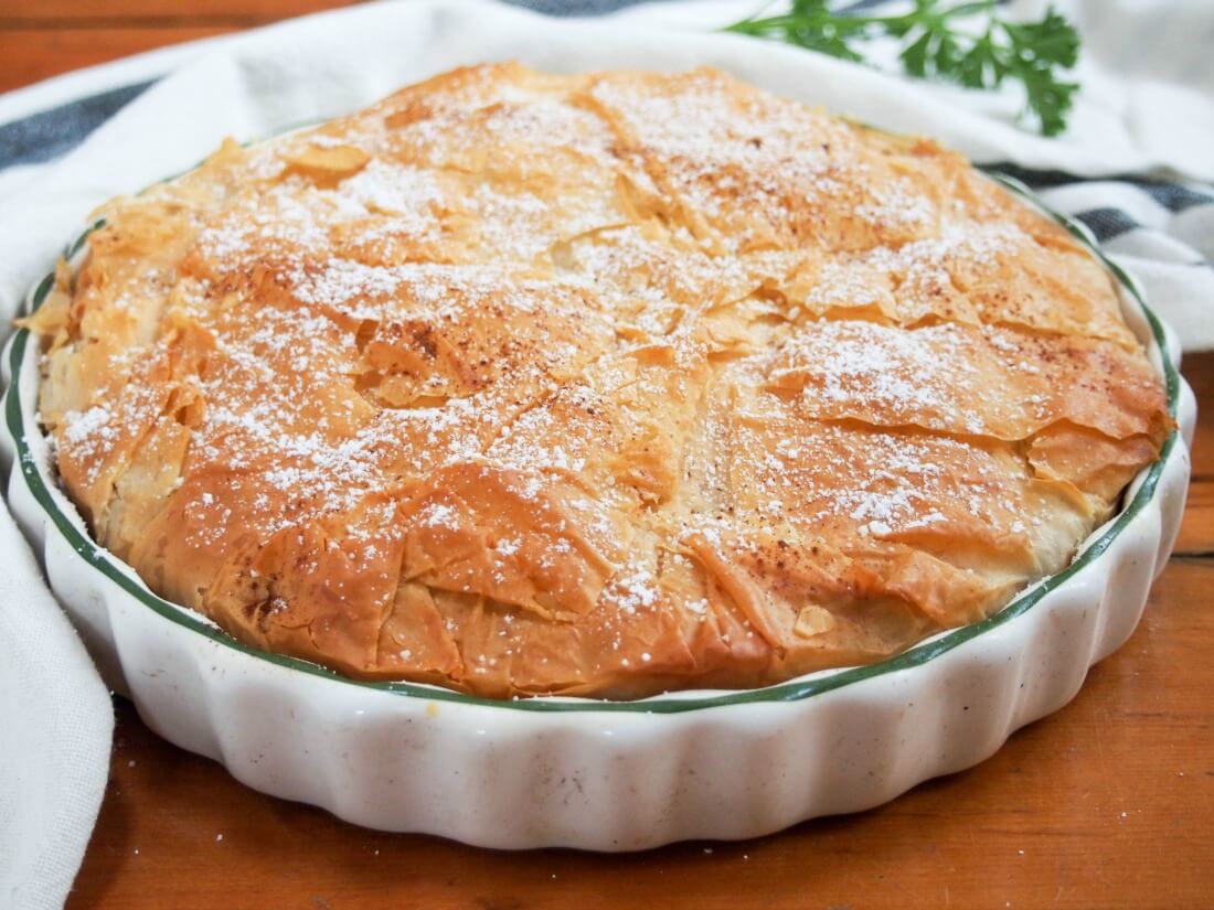 Pastilla is a classic Moroccan pie and what a pie it is - packed with aromatically spiced meat, crisp pastry and a touch of sweet. whole pastilla in round baking dish
