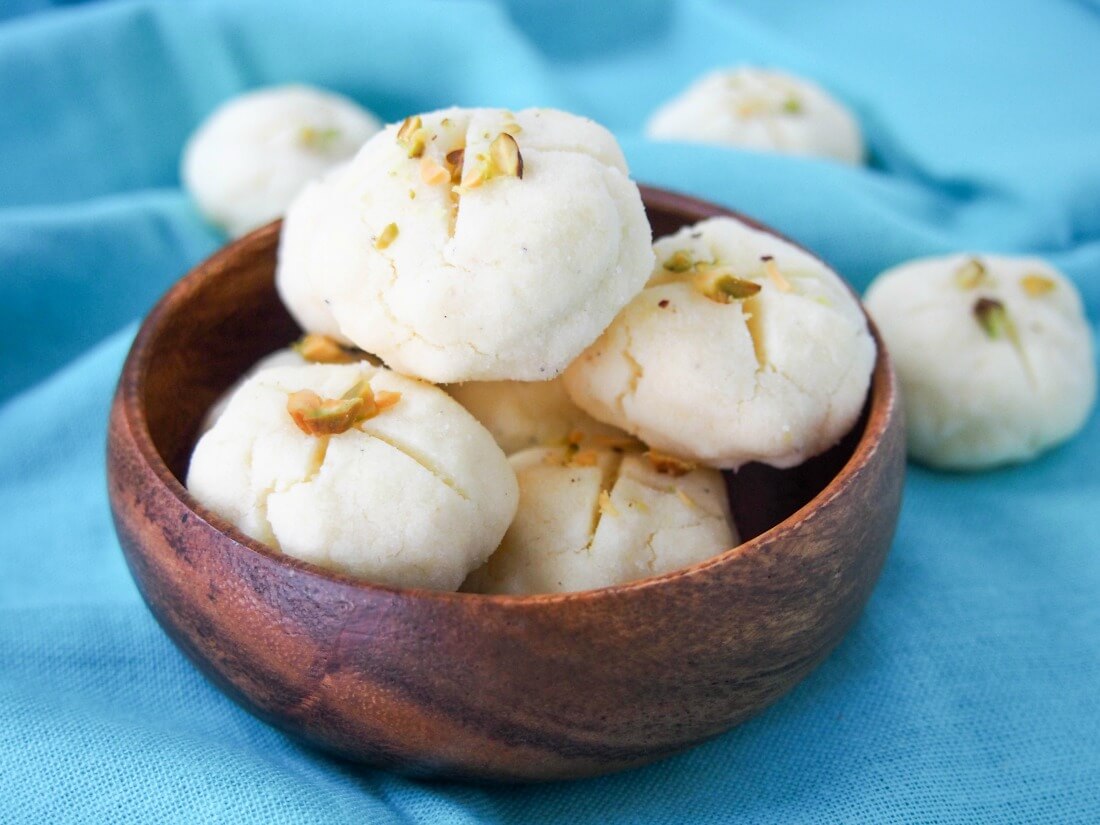 Persian rice cookies (nan-e berenji) typically eaten for Nowruz and other special events, these cookies are naturally gluten free and delicately flavored with rosewater small bowl of Persian rice cookies (nan-e berenji) with couple more behind