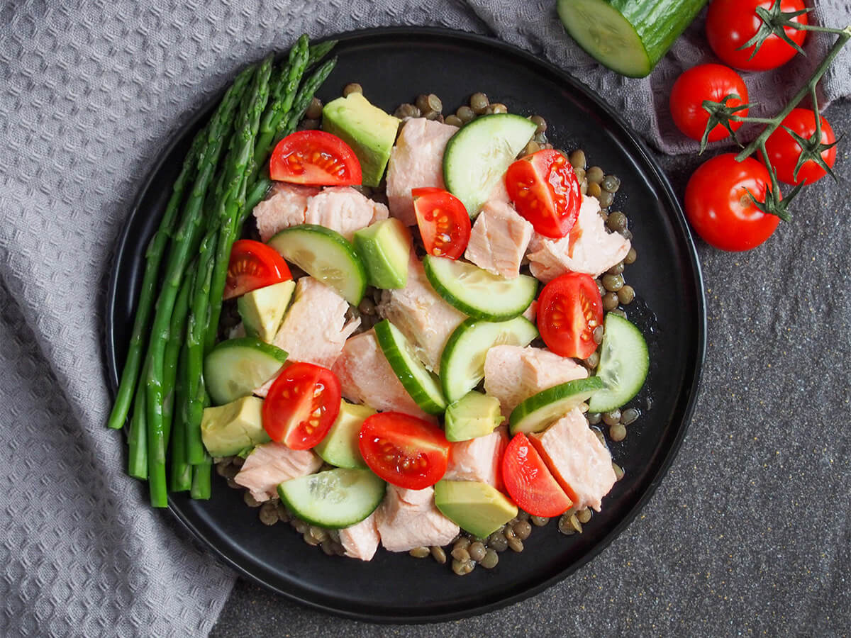 This poached salmon salad is a tasty, light and quick meal. It comes together easily, can be adapted to taste and is perfect when you want something healthier or that avoids using the oven. plate of poached salmon salad