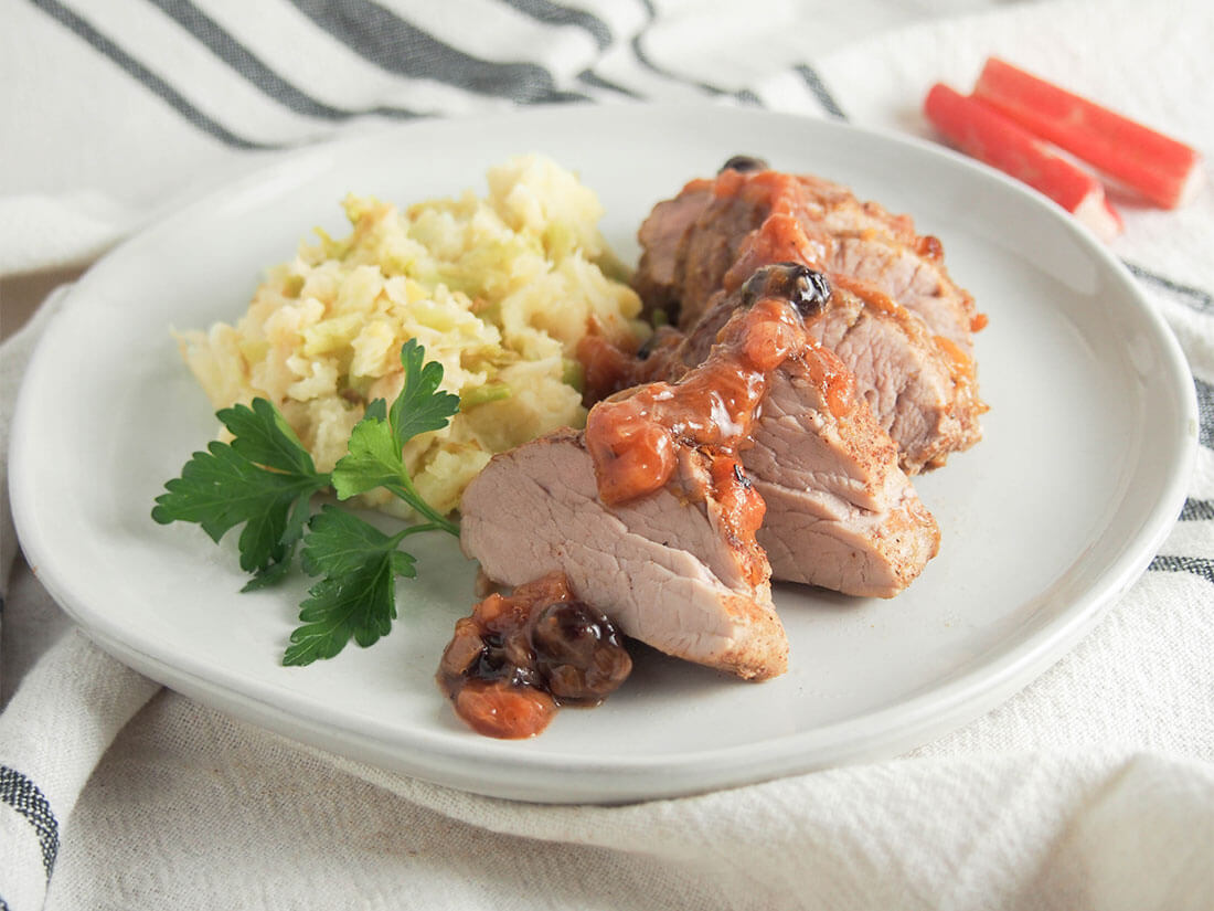 This pork tenderloin with rhubarb chutney is an elegant and easy meal. The delicious sweet-savory flavors of the chutney pair perfectly with tender pork for a quick main, perfect any night. pork tenderloin with rhubarb chutney served with colcannon on white plate