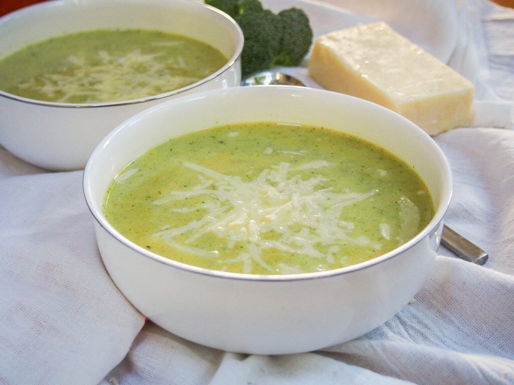 bowl of pumpkin broccoli soup with cheddar - a wonderfully comforting and tasty soup perfect as the weather gets cooler bowl of pumpkin broccoli soup with cheddar with second bowl behind