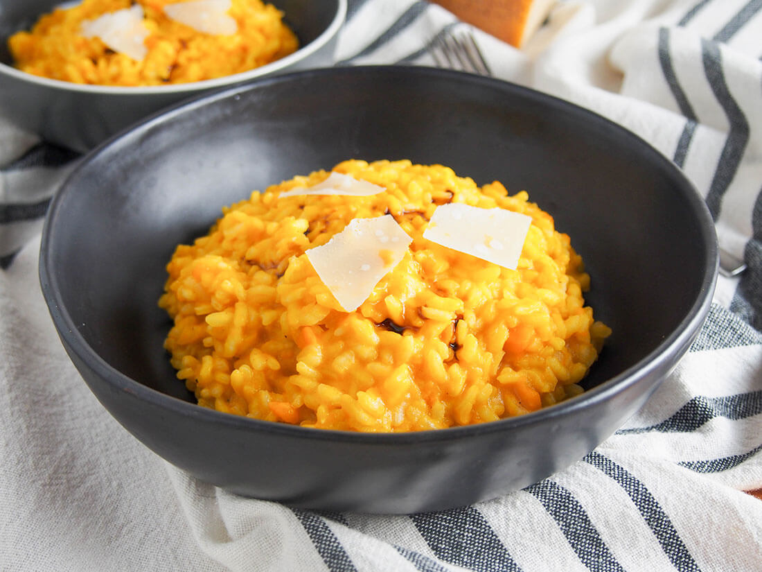 Pumpkin risotto is such a deliciously comforting meal! This version is based on traditional Italian recipes and is easy to make, filling, but not overly heavy. pumpkin risotto in bowl