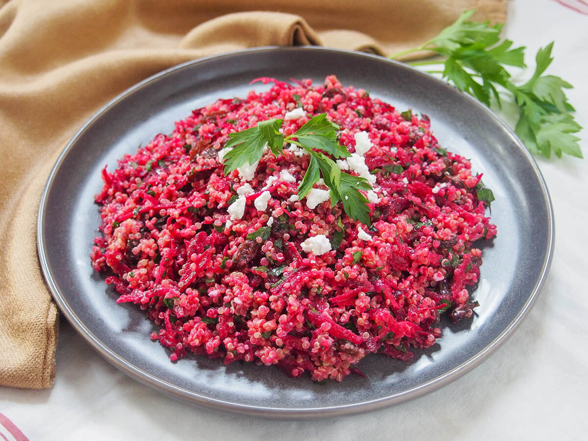 Whether you're looking for a lunch box idea, a potluck dish or a light meal, this raw beet quinoa salad is a great choice. It's bright, light, easy and delicious. Not to mention versatile too. plate of raw beet quinoa salad garnished with parsley