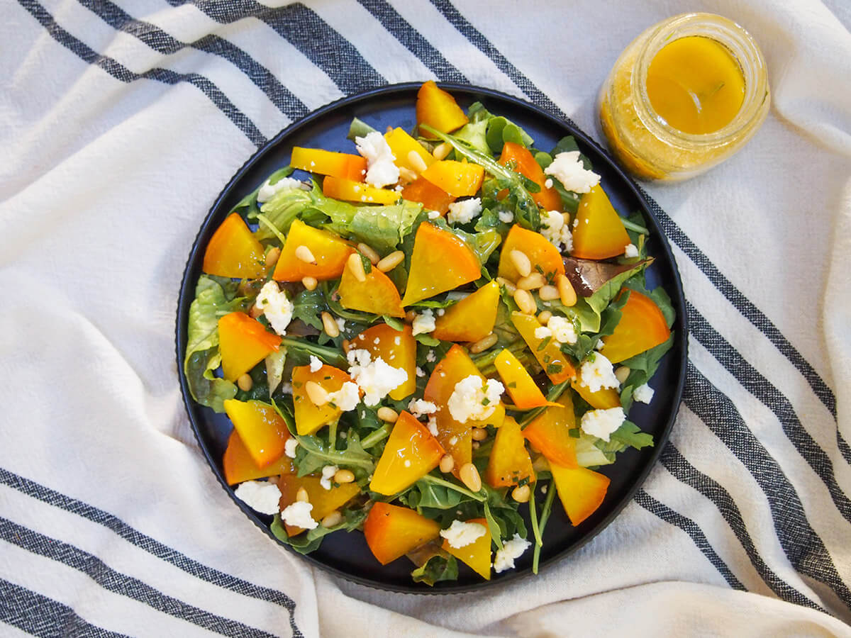 This roasted golden beet salad is a simple combination of beets, greens, a little goat cheese and dressing. They work so well together to make a tasty side or light lunch that's easy to adapt, too. plate of roasted golden beet salad from overhead
