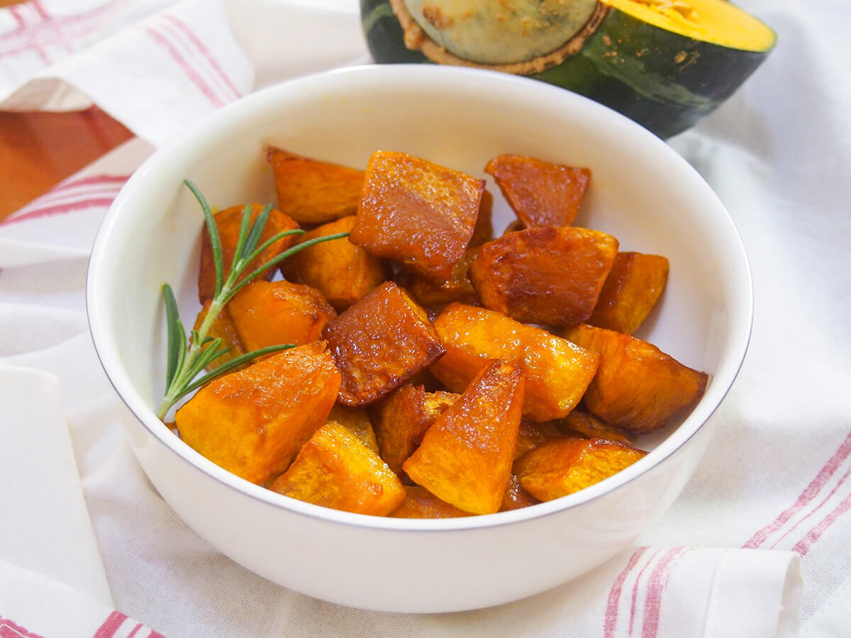 Wondering what to do with buttercup squash? This maple roasted version is the perfect answer - so easy to prepare with fantastic flavor. A great, versatile side. bowl of maple roasted buttercup squash with sprig of rosemary in side of bowl