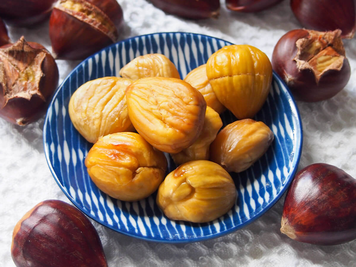 To me, the smell of street carts roasting chestnuts over hot coals is hard to resist. But you don't need a fire to enjoy these tasty nuts: I'll show you how to roast chestnuts in your oven, with plenty of tips along the way. plate of roasted chestnuts with some whole ones and some to peel to side