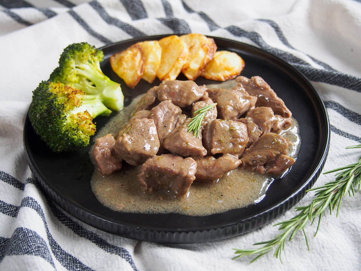 This traditional Roman lamb stew, abbacchio alla cacciatora, uses a relatively simple combination of ingredients including rosemary, garlic and vinegar to create a wonderfully comforting and flavorful dish. Easy and delicious. plate of Roman lamb stew, abbacchio alla cacciatora, with broccoli and potatoes