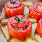 close view of a tomato stuffed with rice in dish