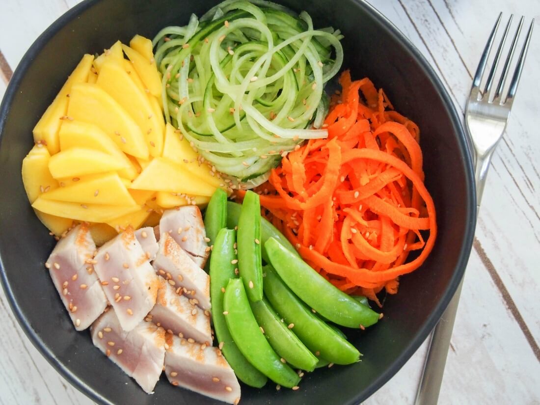 Packed with simple, fresh ingredients, this seared tuna and veggie bowl is a great way to eat healthily without skimping on flavor. It's also easy to make, so win, win! Seared tuna and veggie bowl from overhead with fork to side