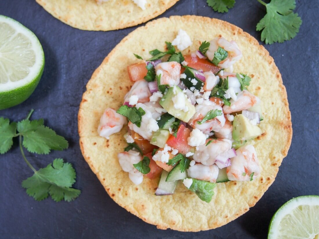 Shrimp ceviche tostadas may be a little messy but they're a delicious mix of textures and flavors Shrimp ceviche tostada from overhead with limes to side