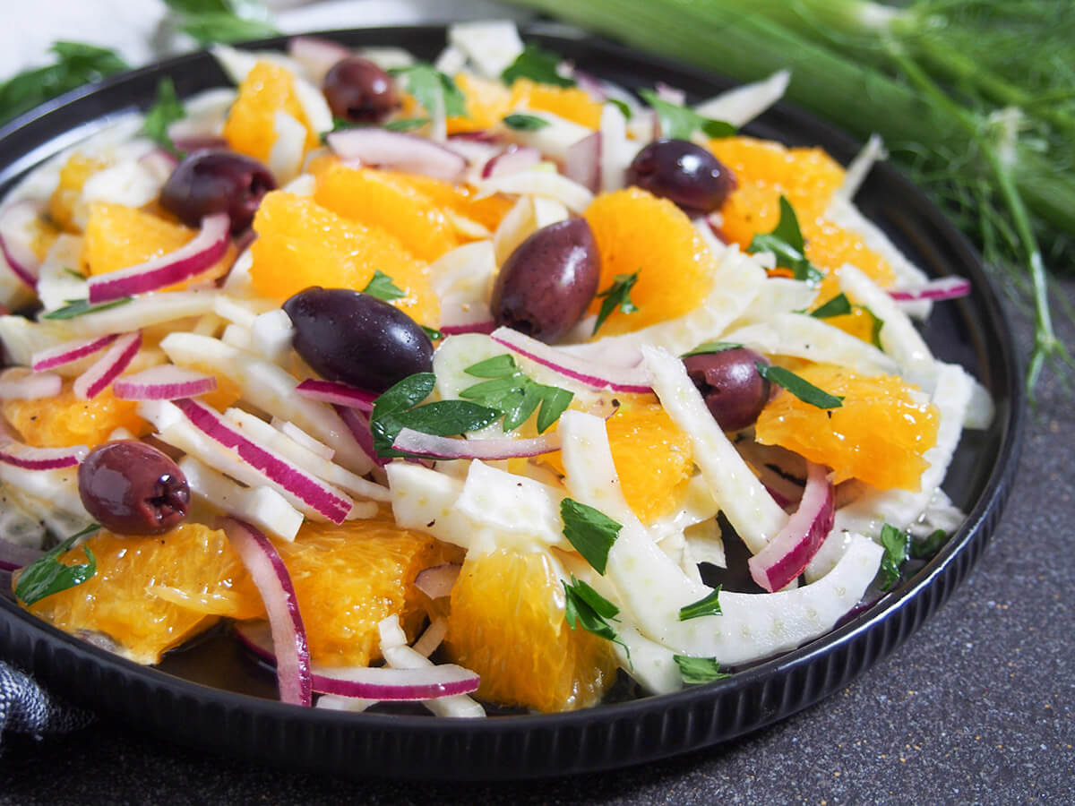 This Sicilian fennel orange salad is incredibly simple but has a fantastic mix of sweet juiciness and savory crunch. It makes a great side salad or light lunch. Sicilian fennel orange salad close view of plate