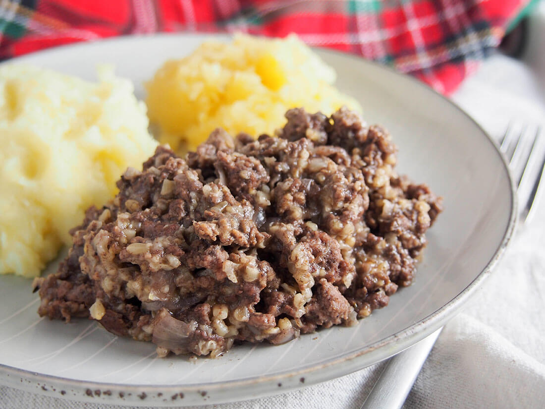 Whether you're craving haggis but can't find it, or are vaguely tempted to try it but a little unsure, this simplified recipe is for you. All the flavors of the classic Scottish dish with easier to find (and more familiar) ingredients. simplified haggis on plate with 'neeps and tatties'
