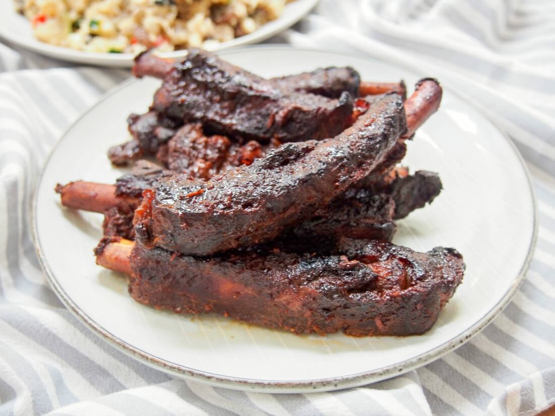 These Chinese spare ribs are cooked in the slow cooker but tasting them, you'd hardly know they are so easy. Tender meat, packed with flavor. Yes, you get a bit sticky but that's half he fun of ribs, right? plate of slow cooker Chinese spare ribs