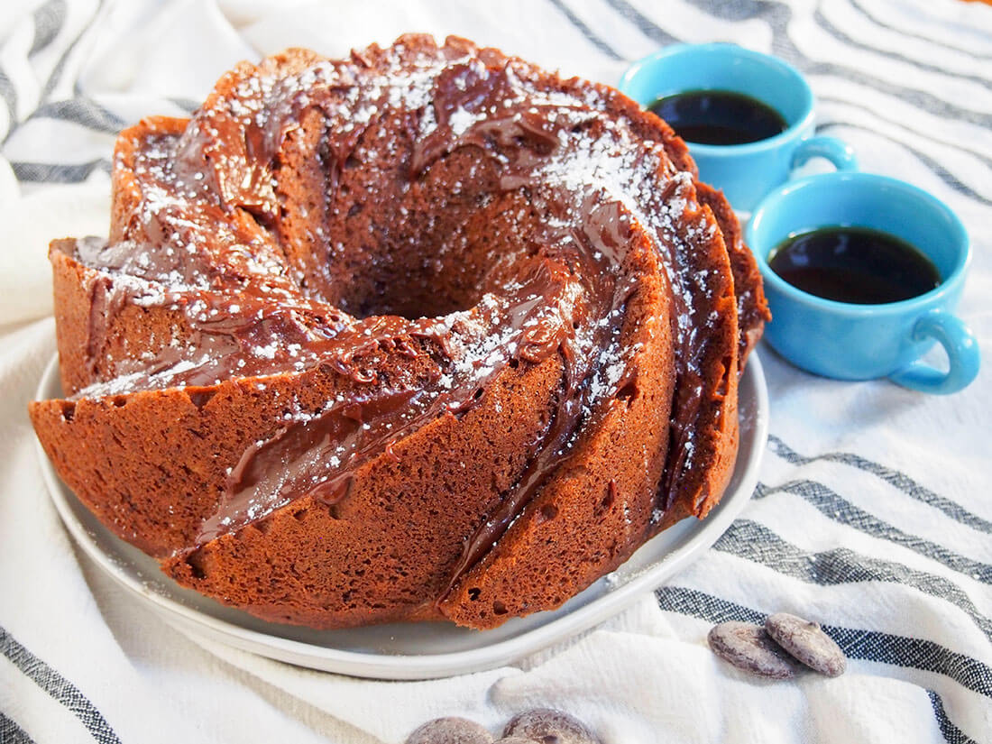 sour cream mocha cake is a delicious flavor combination, with a tender crumb whole sour cream mocha cake with two cups of coffee to side