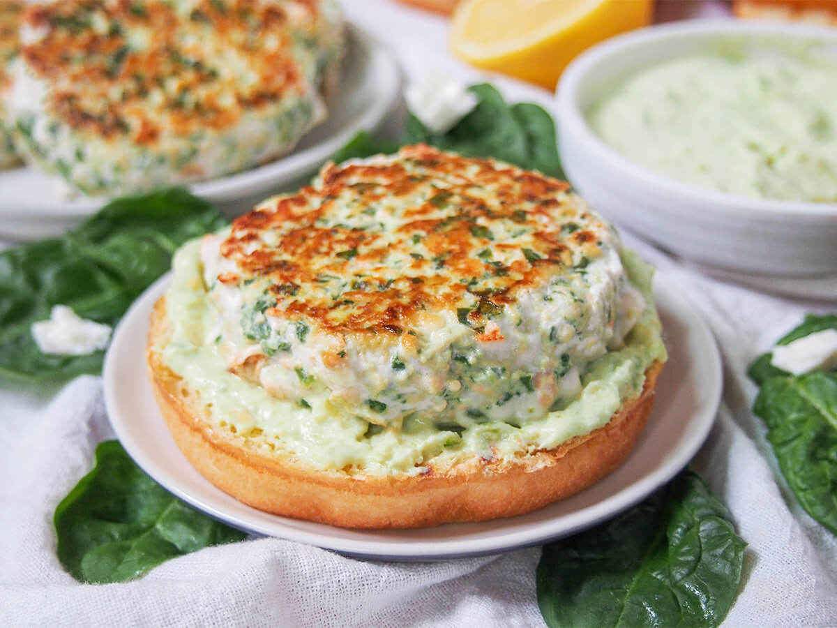 This spinach feta salmon burger makes a tasty, relatively healthy alternative to a traditional burger that's also really quick to make. Juicy, flavorful, so good. spinach feta salmon burger on small plate